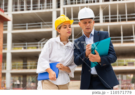 Civil engineers checking work process in construction site Civil engineers checking work process in construction site 110571779