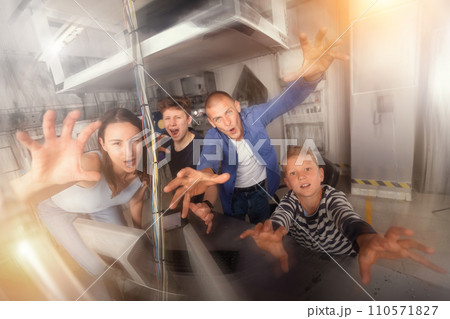 Friendly family has fun in the quest room, stylized as a laboratory Friendly family has fun in the quest room, stylized as a laboratory 110571827
