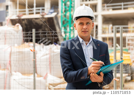Young man architect writes important work notes Young man architect writes important work notes 110571853