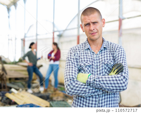 Man in a greenhouse 110572717