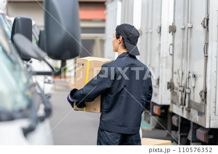 トラックの前で立つ若い男性 トラックの前で立つ若い男性 110576352