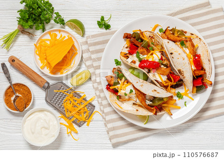 baked tex-mex chicken fajitas on a plate, top view baked tex-mex chicken fajitas on a plate, top view 110576687