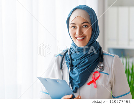 Female doctor with pink ribbon Female doctor with pink ribbon 110577462