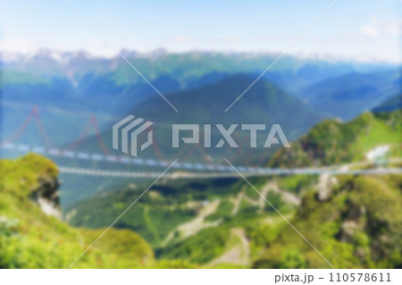 defocused blurred view ofrope suspension bridge over caucasus mountains. No people 110578611