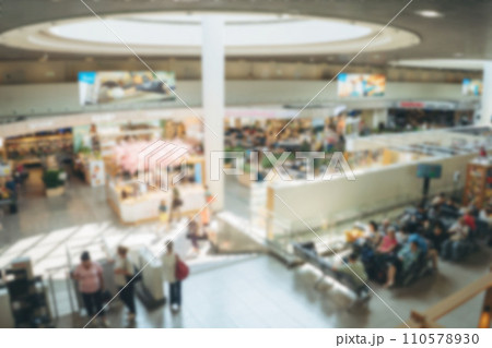 defocused background of busi airport terminal. People waiting for flight, stores and cafe area 110578930