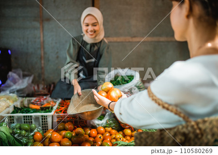 customer hand putting greengrocery products into bucket customer hand putting greengrocery products into bucket 110580269