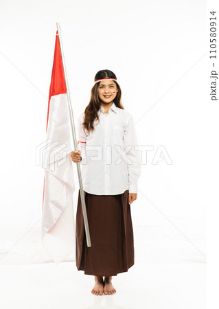 a beautiful asian woman standing bring the indonesian flag and smiling a beautiful asian woman standing bring the indonesian flag and smiling 110580914