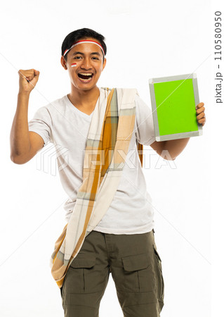 a handsome man standing showing the tablet and smiling a handsome man standing showing the tablet and smiling 110580950