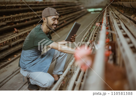 Young entrepreneur enjoy working with tablet while check eggs 110581388