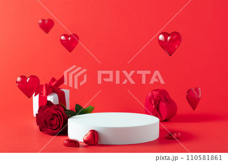 Abstract empty white podium with heart and rose flowers on red background Abstract empty white podium with heart and rose flowers on red background 110581861