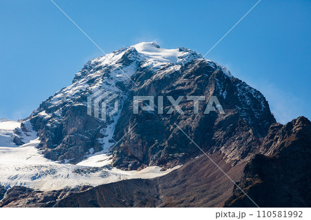 Snow-capped mountains rise majestically along the horizon Snow-capped mountains rise majestically along the horizon 110581992