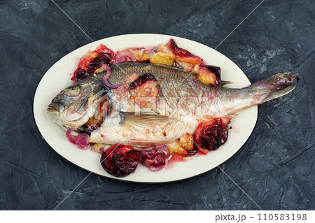 Dorado fish baked on a white plate. Dorado fish baked on a white plate. 110583198