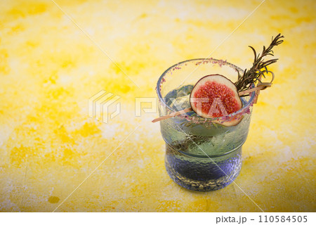 Purple fig cocktail or mocktail in glass Purple fig cocktail or mocktail in glass 110584505