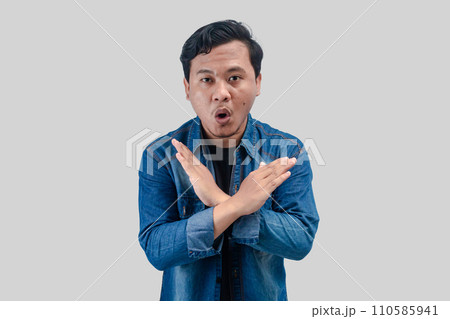 Young Asian Man unhappy or confident standing wear holding two cross arms 110585941