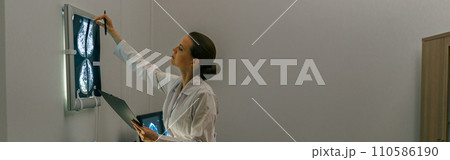 Side view of professional doctor radiologist analyzing scan MRI images in medical center 110586190