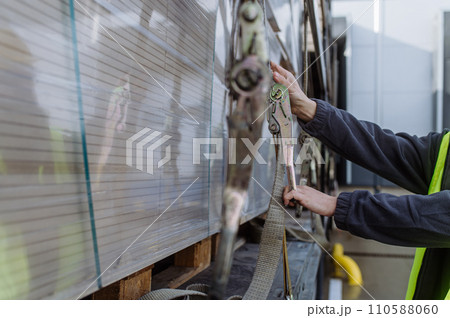Warehouse receivers unloading of the truck in front of warehouse, checking delivered items. Warehouse receivers unloading of the truck in front of warehouse, checking delivered items. 110588060