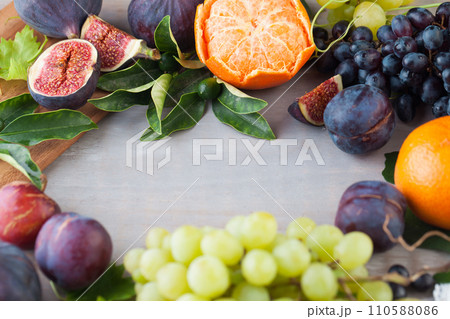 Healthy fruit background border frame on gray wood board. Organic food Healthy fruit background border frame on gray wood board. Organic food 110588086