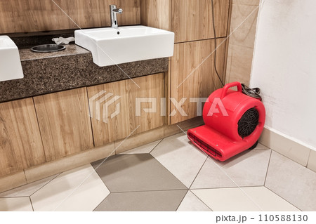 Floor dryer fan used in public washroom and toilet to dry the floor after washing and cleaning Floor dryer fan used in public washroom and toilet to dry the floor after washing and cleaning 110588130