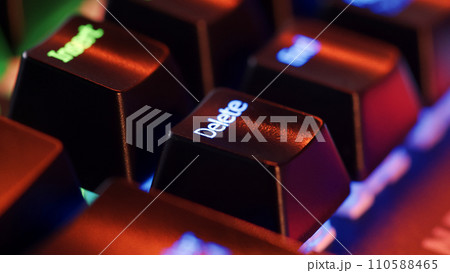 Keyboard key - Delete - macro shot. Modern gaming keyboard close-up with beautiful color backlight. Macro shooting of the rgb computer keyboard with backlight. Low angle view with soft focus. Keyboard key - Delete - macro shot. Modern gaming keyboard close-up with beautiful color backlight. Macro shooting of the rgb computer keyboard with backlight. Low angle view with soft focus. 110588465
