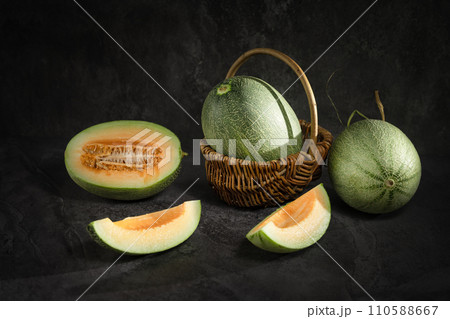 fresh melon on black background fresh melon on black background 110588667
