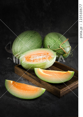 fresh melon on black background fresh melon on black background 110588677