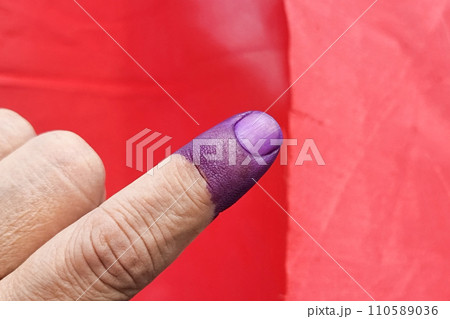 Closeup of purple indelible ink on index finger. Used in election in Malaysia to prevent fraud. Closeup of purple indelible ink on index finger. Used in election in Malaysia to prevent fraud. 110589036