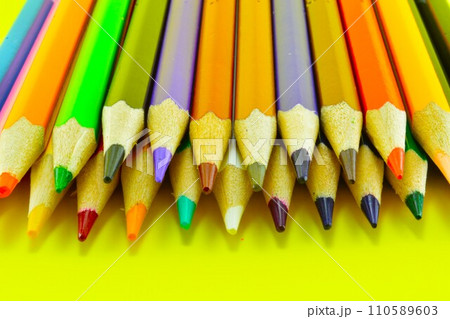 colored pencils on a yellow background colored pencils on a yellow background 110589603