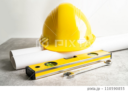 Architectural house plan project blueprint and yellow helmet with calculator, engineer construction tools. Architectural house plan project blueprint and yellow helmet with calculator, engineer construction tools. 110590855