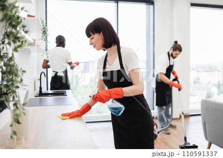 Housekeeper team in uniform apron cleaning service team at home 110591337