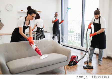 Focus on positive African American worker cleaning panoramic window. 110591403