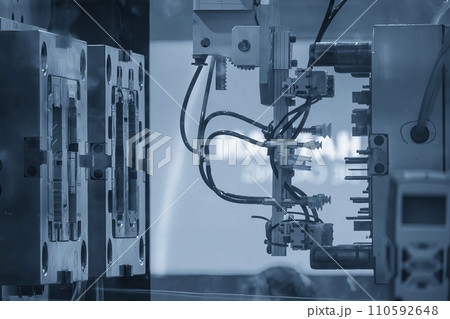 The plastic injection parts gripping by  vacuum robotic system from injection machine. The plastic injection parts gripping by  vacuum robotic system from injection machine. 110592648