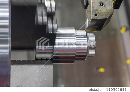 The  CNC lathe machine forming  cutting the metal shaft parts. 110592651