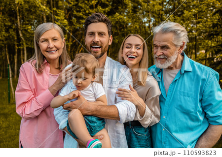 Happy family smiling and looking joyful on the nature background Happy family smiling and looking joyful on the nature background 110593823
