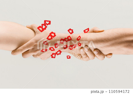 Human hands holding over many social media likes. Online popularity, influence, support, friendship 110594172