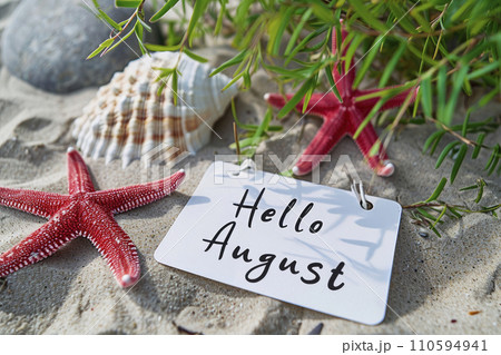 Phrase "Hello August" written on white note, beach and starfish background Phrase "Hello August" written on white note, beach and starfish background 110594941