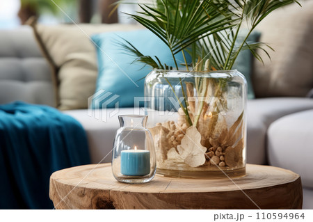 Interior decoration in a marine style, candle shells and palm leaves in glass bottles. Place to relax and read. Interior decoration in a marine style, candle shells and palm leaves in glass bottles. Place to relax and read. 110594964