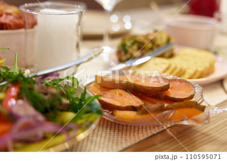 festive table with red fish. banquet table with appetizers. 110595071
