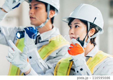 建設現場でトランシーバーを使う作業員 建設現場でトランシーバーを使う作業員 110595086