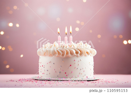 White birthday cake with icing on light pink studio background 110595153