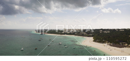Sandy beach and green ocean in zanzibar at cloudy day Sandy beach and green ocean in zanzibar at cloudy day 110595272