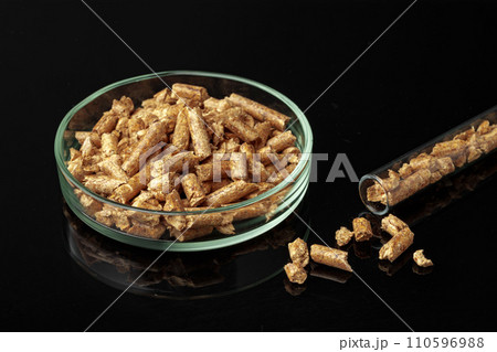 Heap of wood pellets biofuel on black background Heap of wood pellets biofuel on black background 110596988