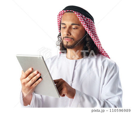 Arab man using digital tablet wearing traditional clothes isolated on white Arab man using digital tablet wearing traditional clothes isolated on white 110596989
