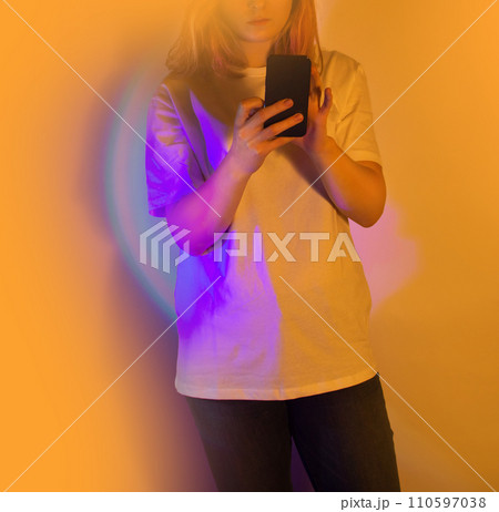Happy woman holding a smartphone and receiving a new message Happy woman holding a smartphone and receiving a new message 110597038
