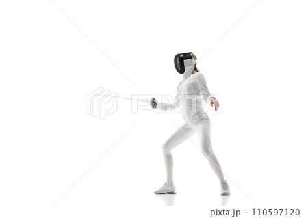 Sports training. An athlete demonstrating the skill and form developed through dedicated sports training. Female fencer in motion over white background. Sports training. An athlete demonstrating the skill and form developed through dedicated sports training. Female fencer in motion over white background. 110597120