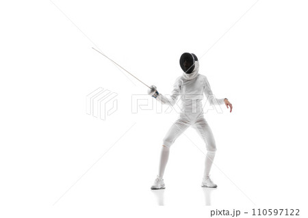 Fencing apparel. Displaying the specialized gear and clothing designed for safety and agility in fencing. Female fencer training over white background 110597122
