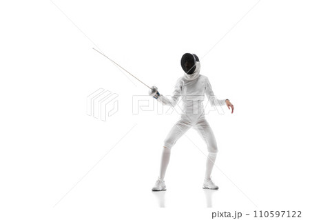 Fencing apparel. Displaying the specialized gear and clothing designed for safety and agility in fencing. Female fencer training over white background Fencing apparel. Displaying the specialized gear and clothing designed for safety and agility in fencing. Female fencer training over white background 110597122