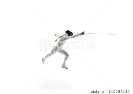 Sports training. An athlete demonstrating the skill and form developed through dedicated sports training. Female fencer in motion over white background 110597139