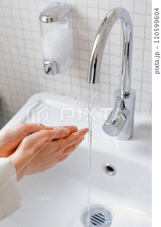 Hands wash procedure, cleaning hands with soap from viruses and contamination. Wash hands before dinner 110599604
