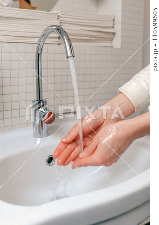 Hands wash procedure, cleaning hands with soap from viruses and contamination. Wash hands before dinner 110599605