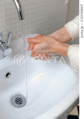 Hands wash procedure, cleaning hands with soap from viruses and contamination. Wash hands before dinner 110599607